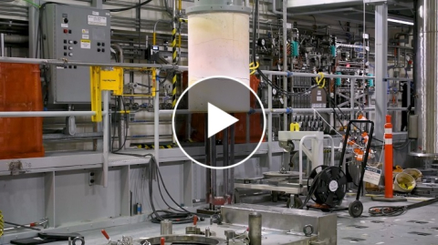 The inside of a melter treatment facility with a play button over it