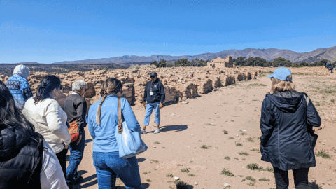 A slideshow of photos of people touring a laboratory in the desert