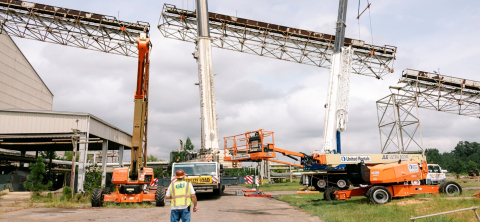 Cranes and construction vehicles work to remove a conveyer