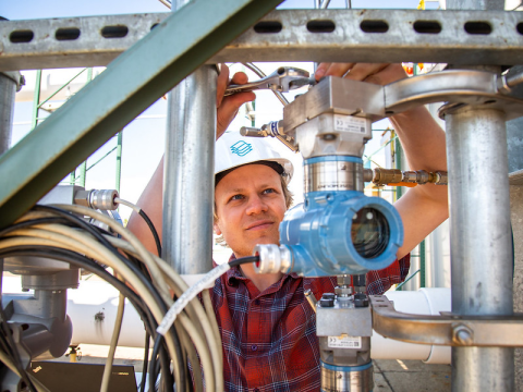 Senior Mechanical Engineer Ian Gagnon adjusts sensors that measure hydraulic efficiency at Natel Energy's hydraulic test facility in Alameda, California.