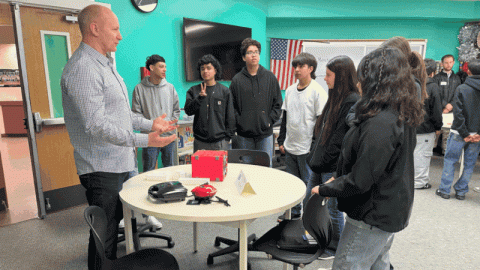 A slideshow of pictures of a STEM event inside a classroom with students and professionals