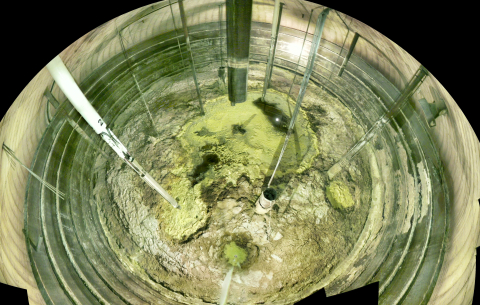 The inside of a tank that stores waste. The bottom is crumbly and dry looking