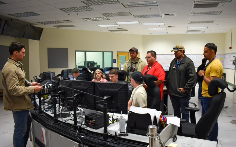 Control room personnel monitor systems.