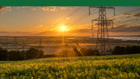Transmission lines and wind turbines at sunset. 