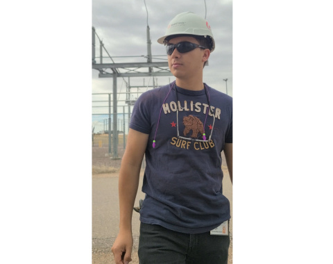 Issac Marchand standing outside wearing a hard hat and sunglasses