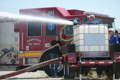 A firetruck spraying water out of its hose