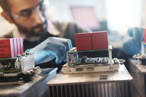 Close up of a researcher working on a power electronics device  