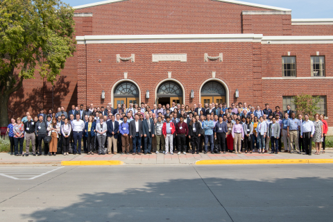 Large group of people in front of a large building. 