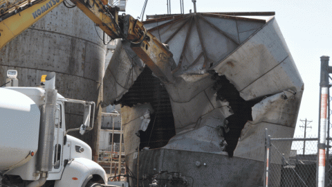 A rotating GIF of images from the demolition of a facility building 
