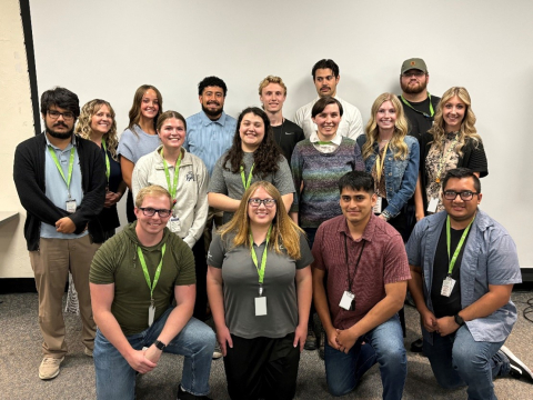 A group of young interns pose for a group photo