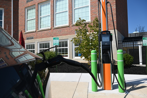 Upclose view of an electric vehicle charger plugged into a car