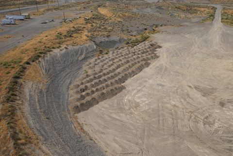 An aerial view of a large gravel and dirt pit