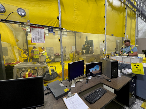 Workers prepare the inner contamination enclosure for waste handling operations at the Advanced Mixed Waste Treatment Project at the Idaho National Laboratory Site.