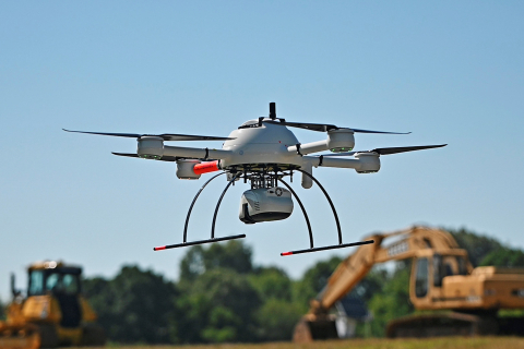 An up close shot of a white drone in the air