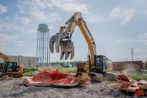 An excavator and remaining scrap metal.