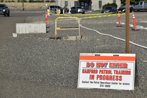 A "do not enter" sign on the ground in a parking lot that is roped off for training exercises 