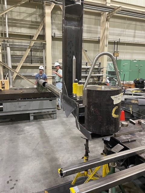 Two workers in protective gear working inside a facility building