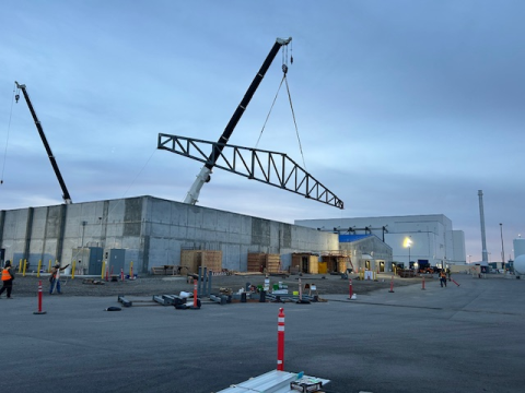 A crane placing part of a building