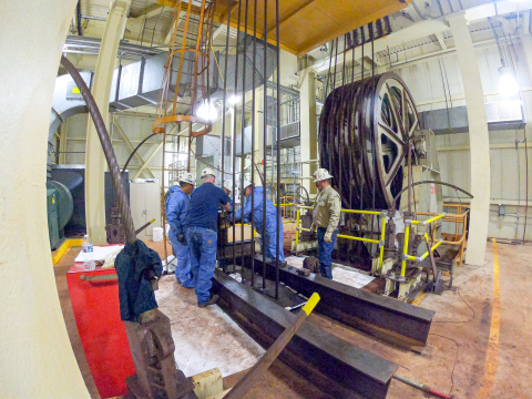 Employees working through a rope change on a machine