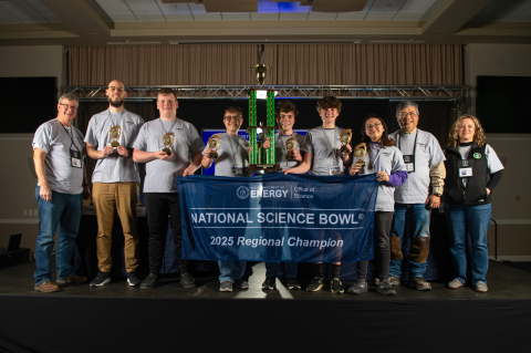 A group of high school students pose for a group picture after winning a science bowl competition