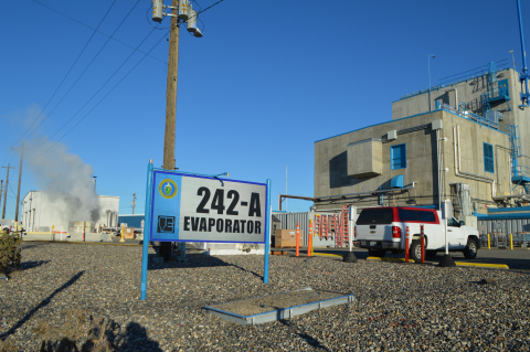 Outside of a boiler facility, a sign in front reads "242-A Evaporator"