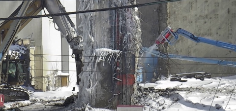 Machines demolishing part of a building