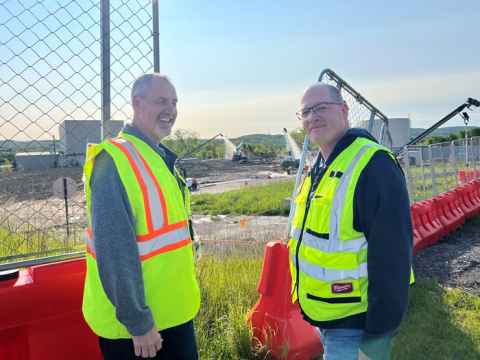 Bryan Bower, West Valley Demonstration Project director, left, and Stephen Bousquet, West Valley assistant director of project management, observe the cover installation over the footprint of the Main Plant Process Building.
