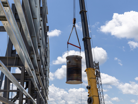 Engineering Test Unit 3.0 reactor vessel being carried by a crane.