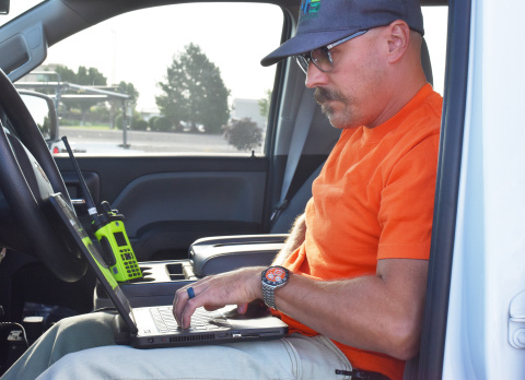 A man using a radio system while sitting in a vehicle at the Hanford Site
