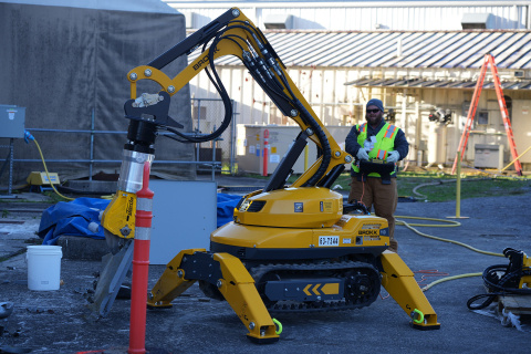 A yellow robot carrying out a demonstration at the Oak Ridge Site
