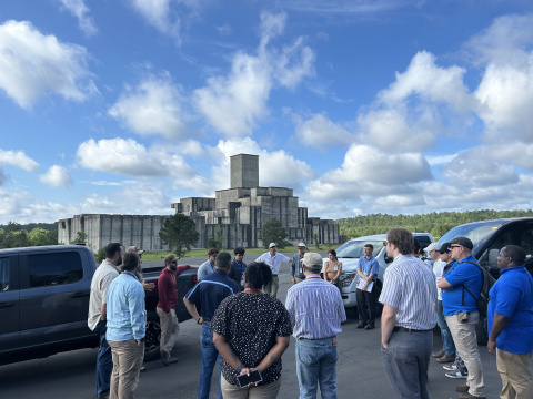 A group of people taking a tour of a basin outdoors