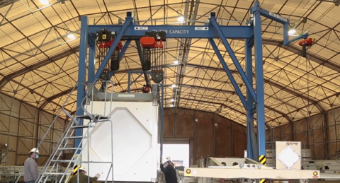 A large blue piece on equipment inside a facility building