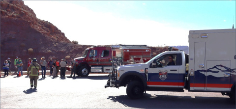 Two emergency vehicles with people surrounding at the Moab Site