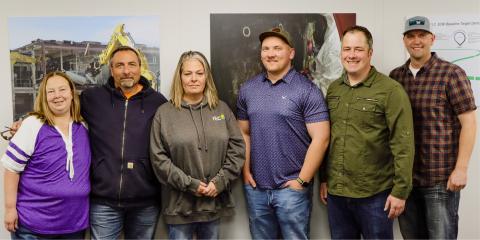 A group of employees pose for a picture together
