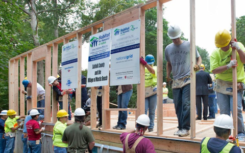The wall-raising ceremony kicked off the day at the build site. Volunteers from Brookhaven Science Associates, Bank of America, and National Grid worked together to raise four walls throughout the day.