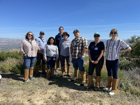 A group of individuals outside at the ETEC site posing for a group picture