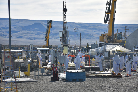 Hanford works removing part of a pump outside at a work site