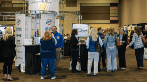 Rotating set of images of Hanford Site representatives at a conference