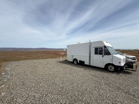 A large white sampling truck parked outside at the Hanford site
