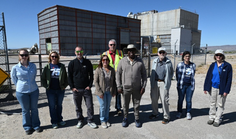 A group of people posing for a photo outside at the Nevada Site
