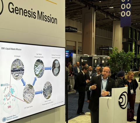 A professional giving a presentation at an Expo on the DOE Genesis Mission