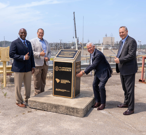 Four Department of Energy Officials pose for a picture outside at the Savannah River Site