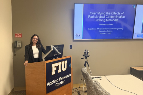 A professional standing behind a podium giving a research presentation