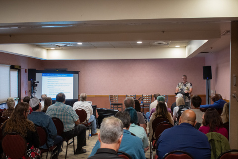A group of people listening to a presentation being given