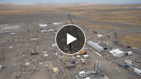An aerial view of a cleared demolition site at the Hanford Site with a play button in the middle of the picture