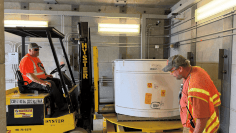 Rotating set of images of containers of waste being prepared for shipment 