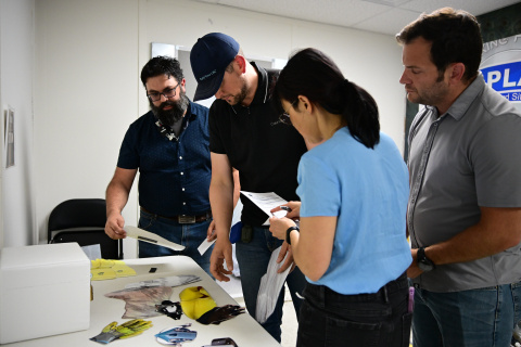 A group of four employees working in an escape room together