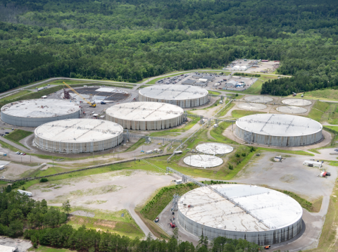 Aerial view of six large circular facility buildings at the Savannah River Site with trees surrounding