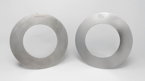 Two circular metal rings on a light grey background