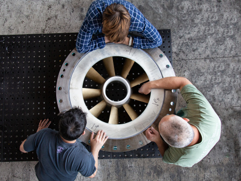 Hydropower researchers gathers around the turbine